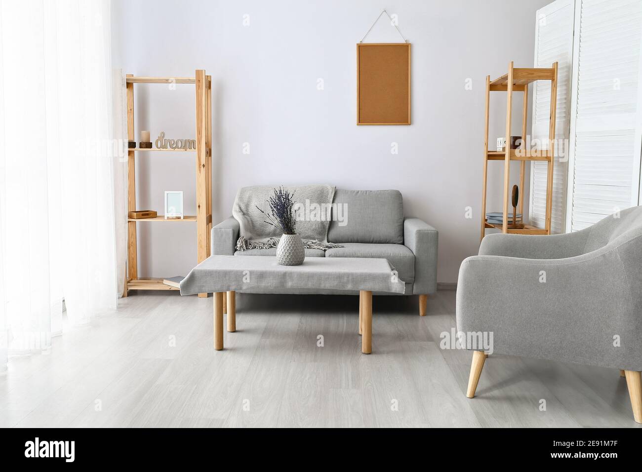 Stylish interior of living room with comfortable sofa Stock Photo - Alamy
