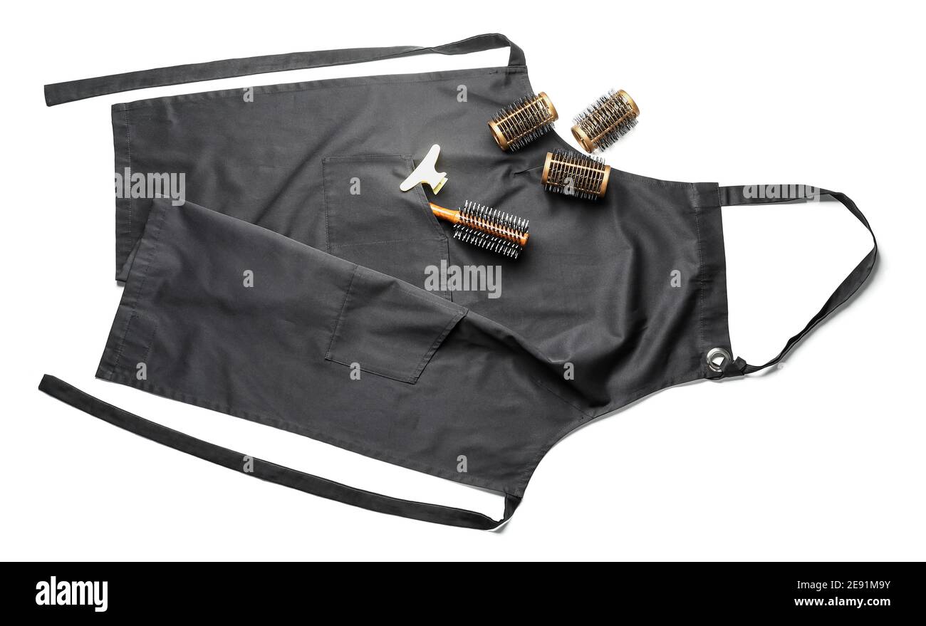 Apron and set of hairdresser&rsquo;s supplies on white background Stock Photo