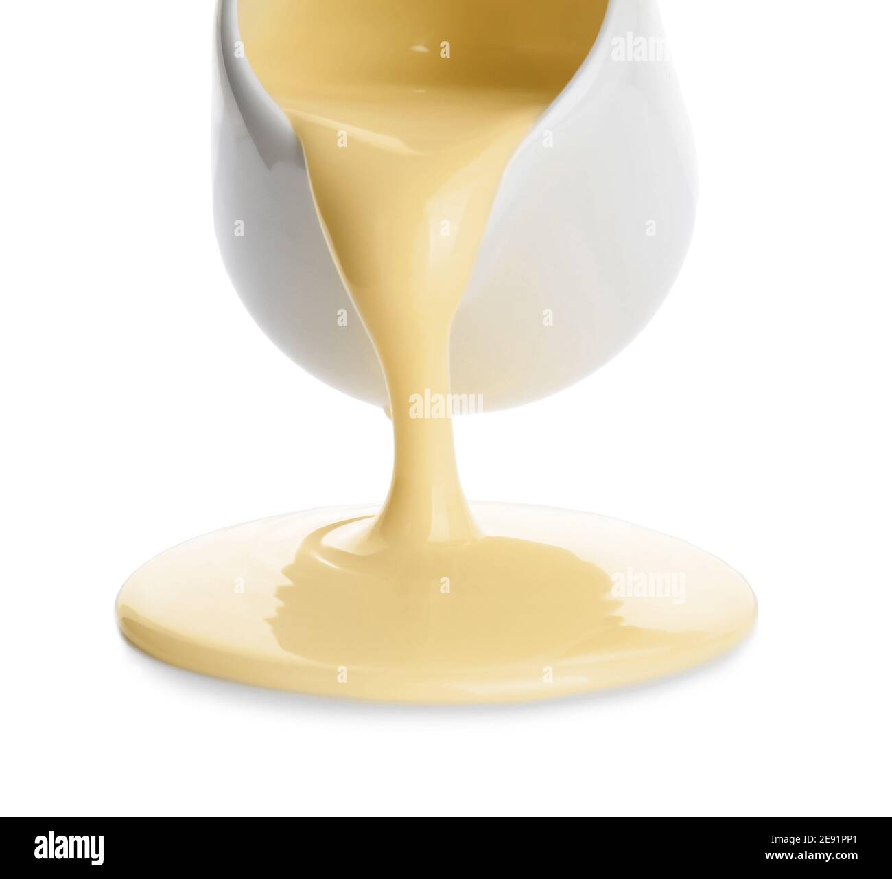 Jug with sweet condensed milk on white background Stock Photo Alamy
