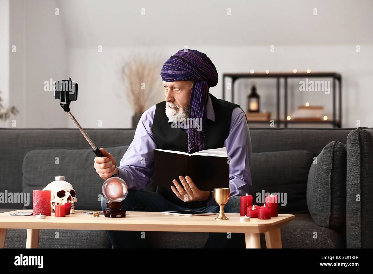 Male fortune teller recording video for blog Stock Photo Alamy