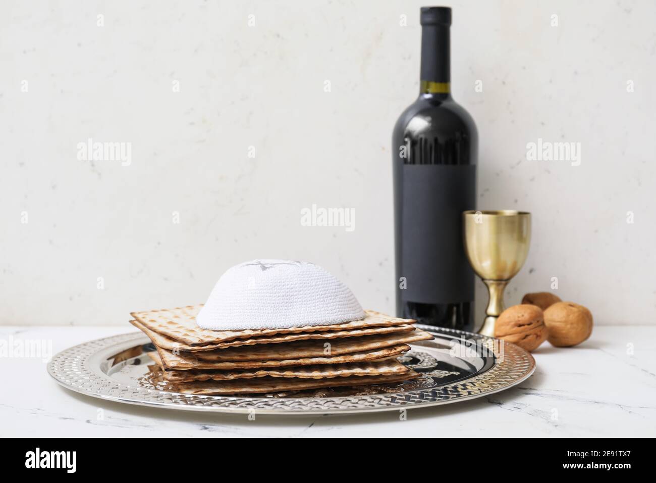 Passover Seder plate with matzo, Jewish cap and wine on table Stock ...