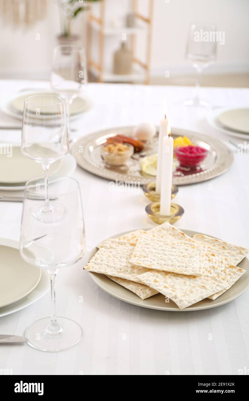 Jewish flatbread matzo on table setting for Passover Seder Stock Photo