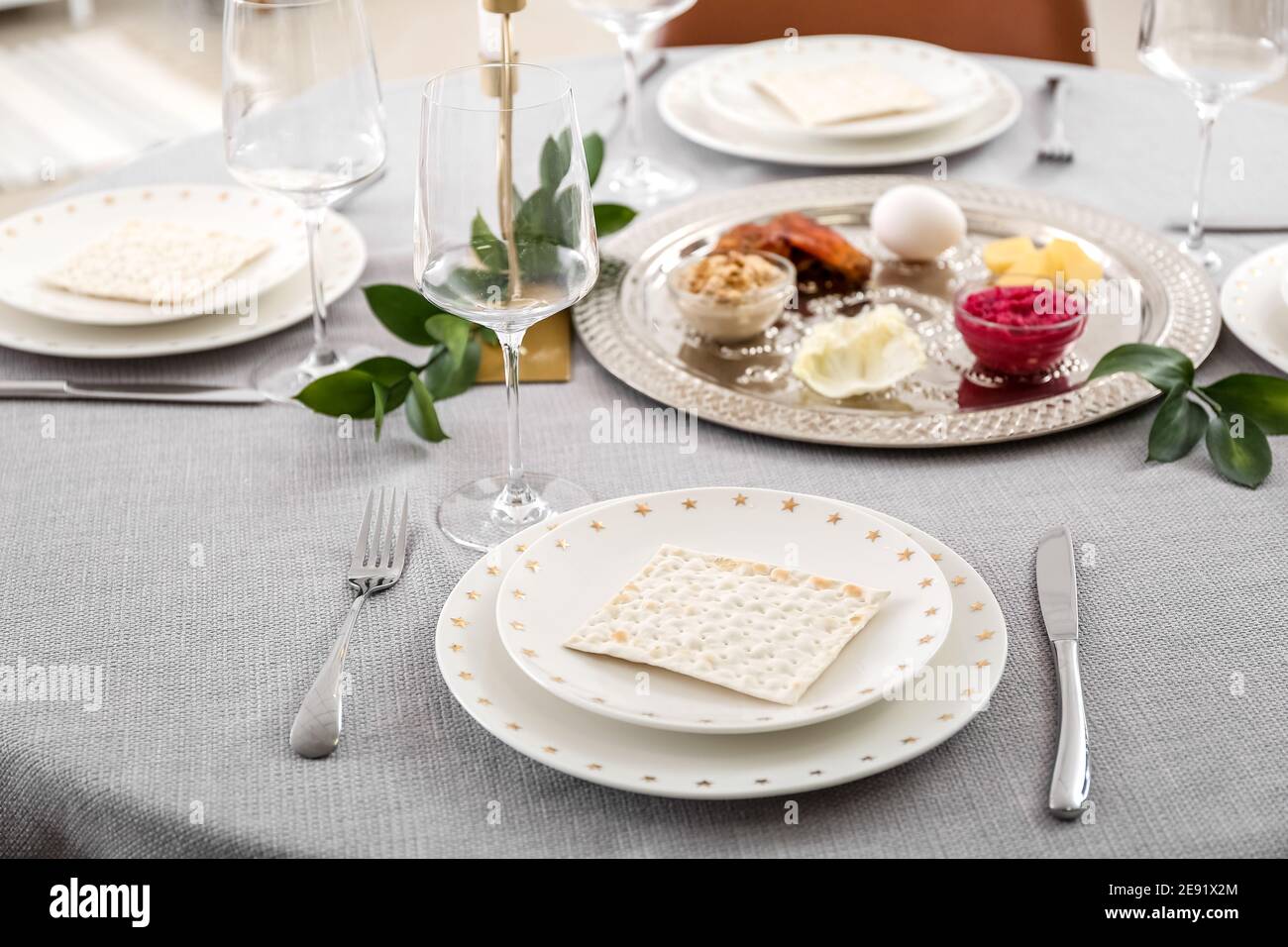 Jewish flatbread matzo on table setting for Passover Seder Stock Photo