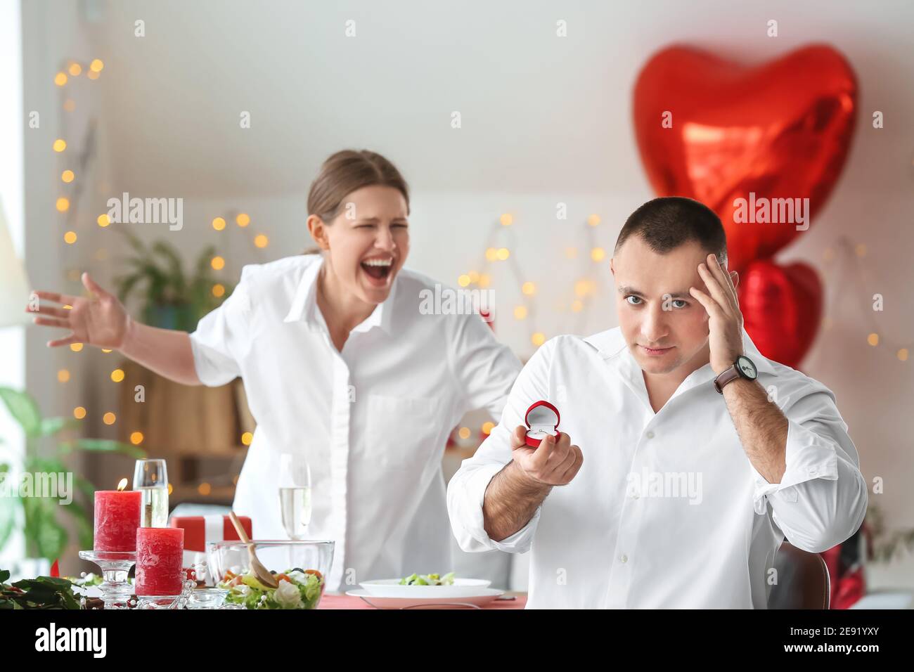 Stressed man after proposal to his angry beloved on Valentine's Day at ...