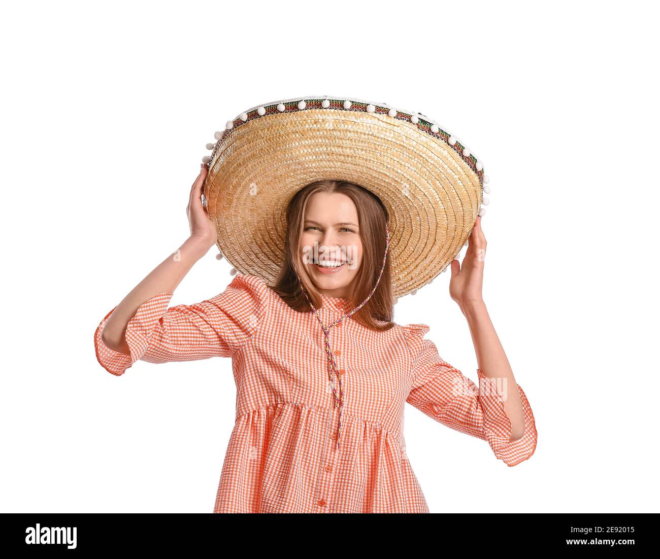 Beautiful young Mexican woman in sombrero hat on white background Stock