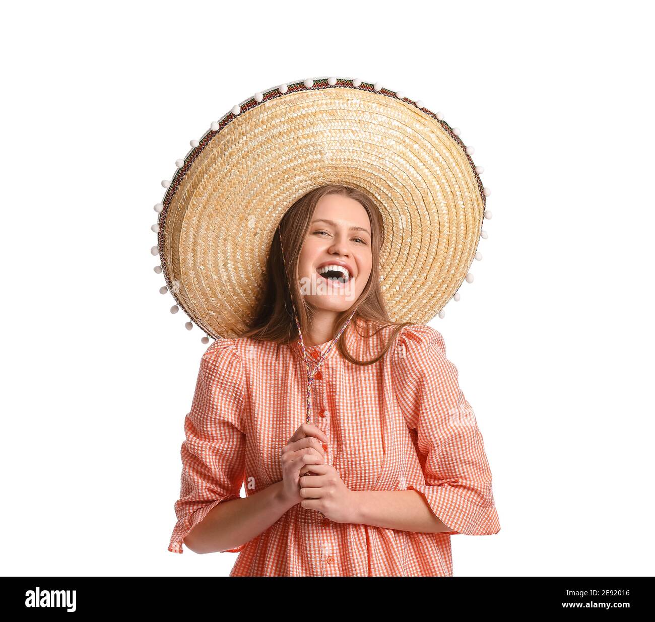 Beautiful young Mexican woman in sombrero hat on white background Stock