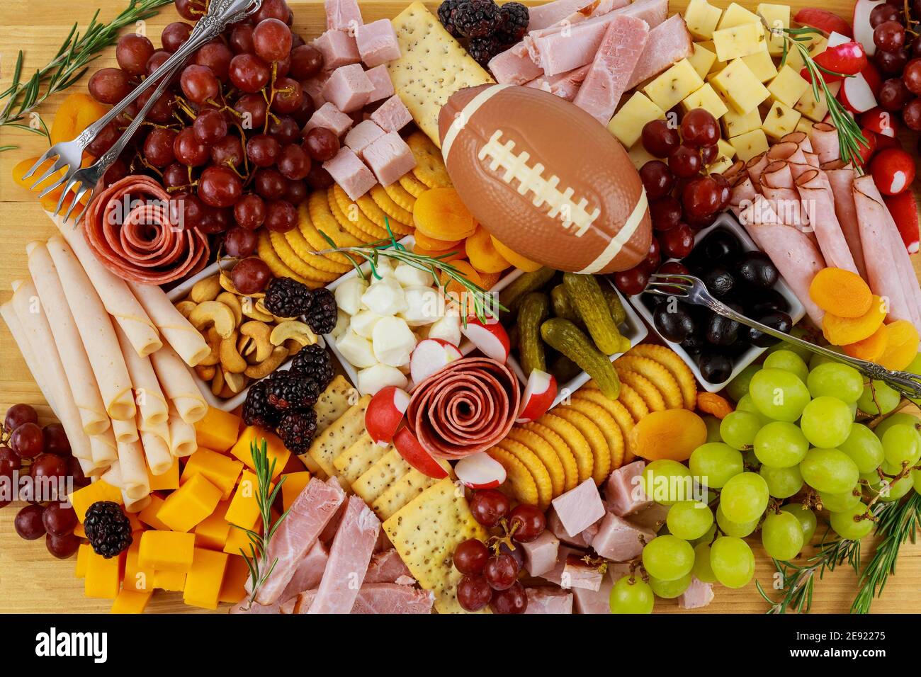 Charcuterie board with cheese, grape, ham and crackers. American