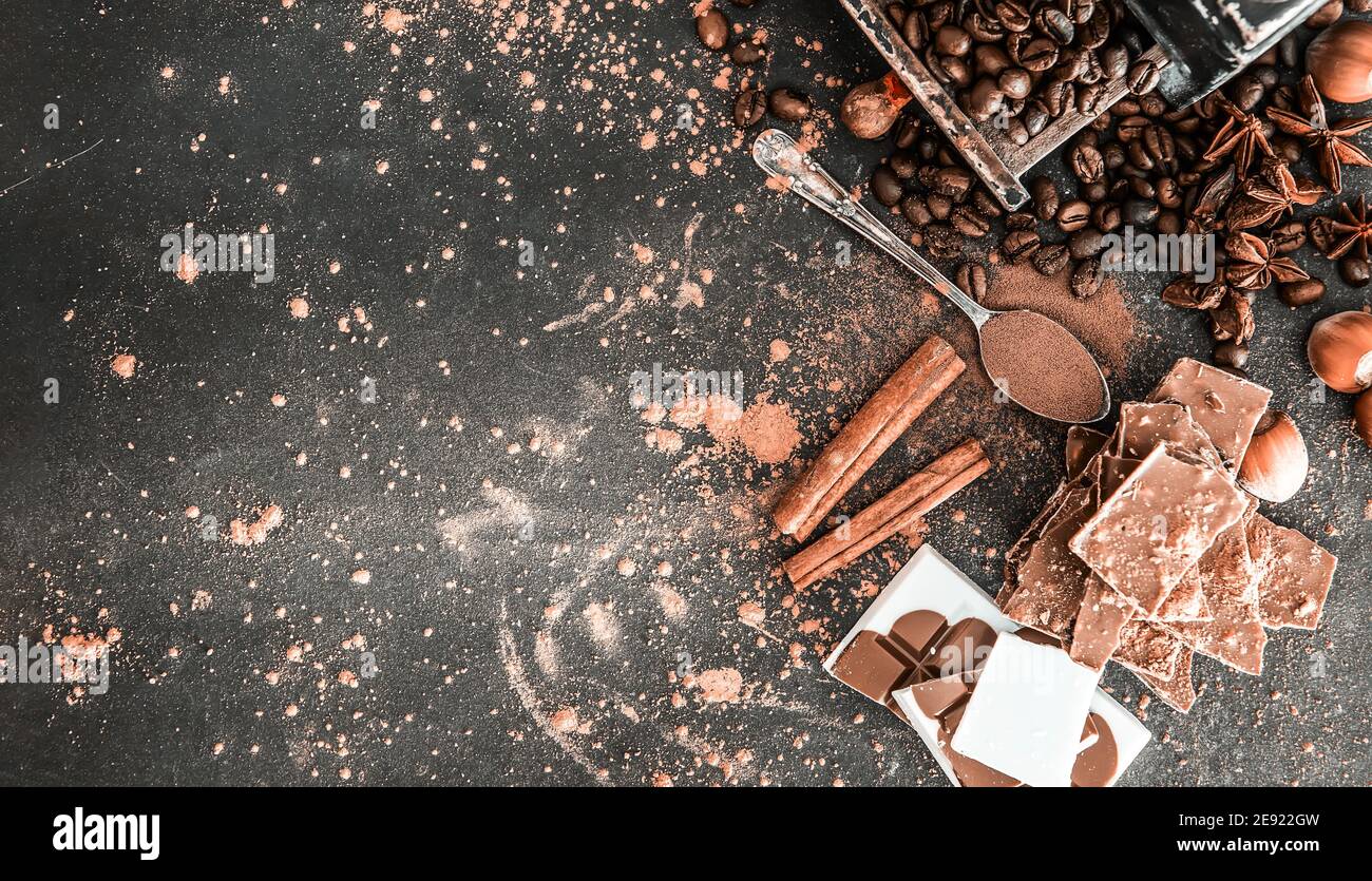 Chocolate, nuts, spices on a smooth black table Stock Photo