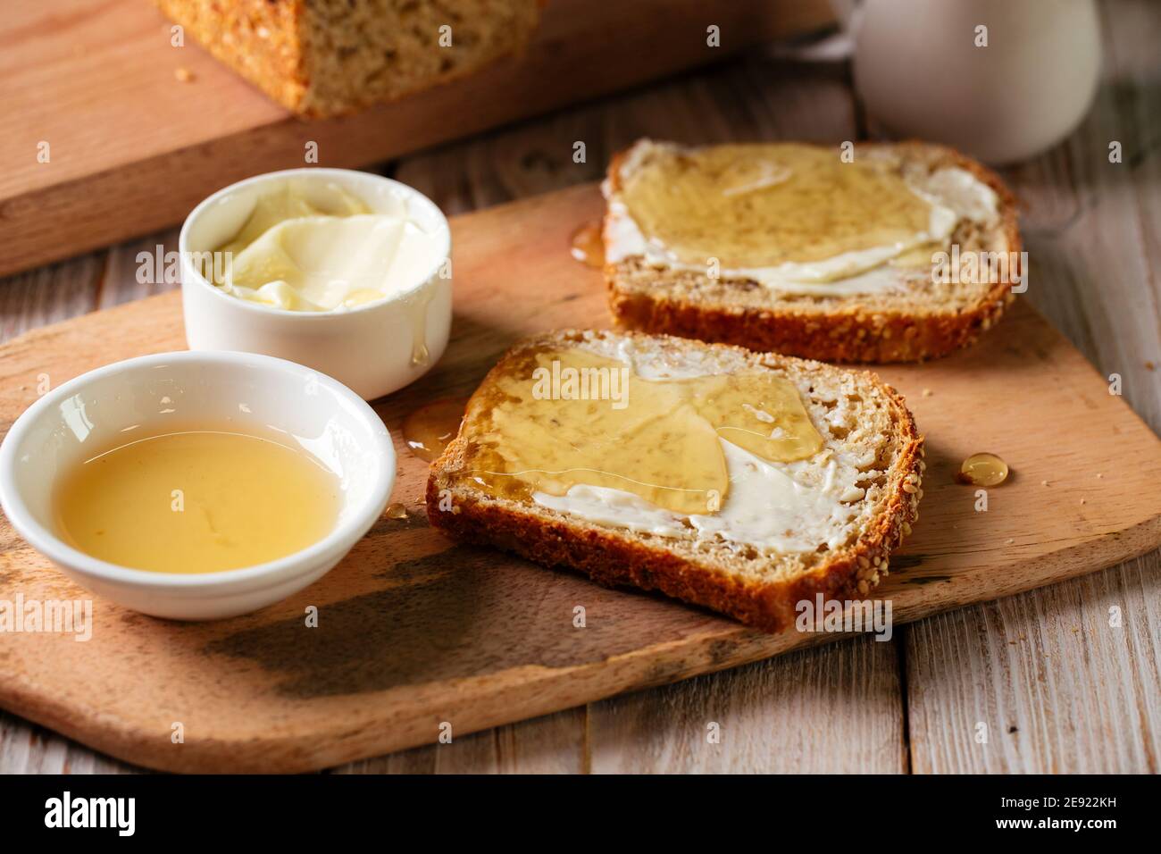 Whole grain bread slices with butter and honey Stock Photo - Alamy