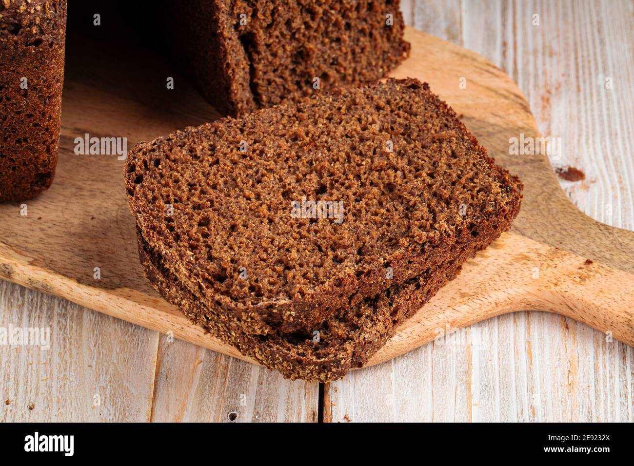 Sliced rye bread on the wooden cutting board Stock Photo