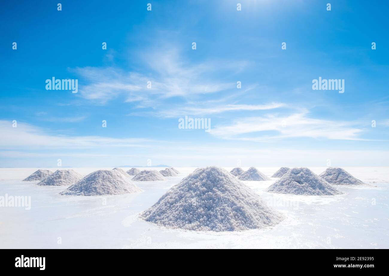 Salt hills of Salar de Uyuni drying on sun at hot clear day, Bolivia Stock Photo