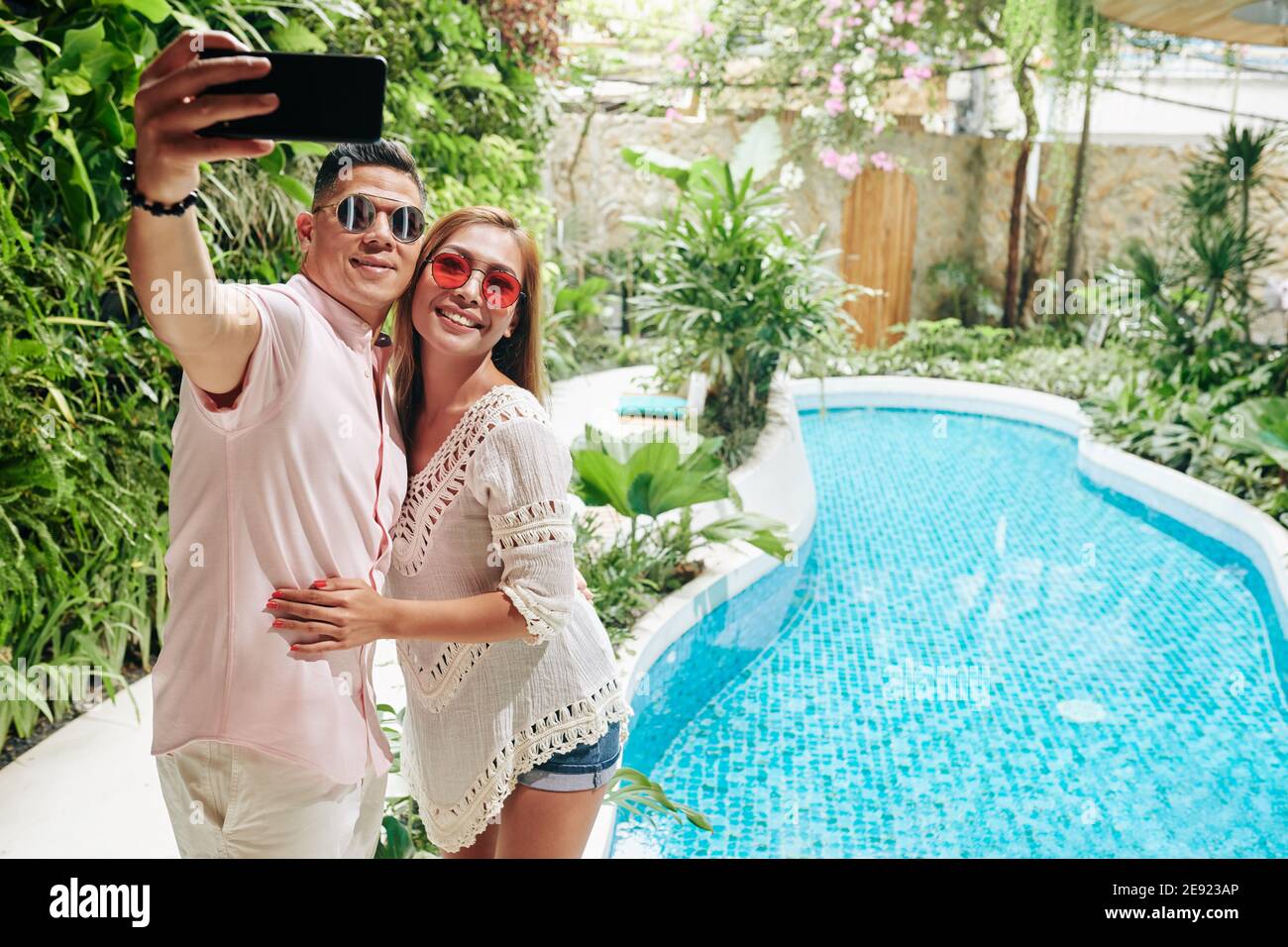 Couple hugging and taking selfie Stock Photo
