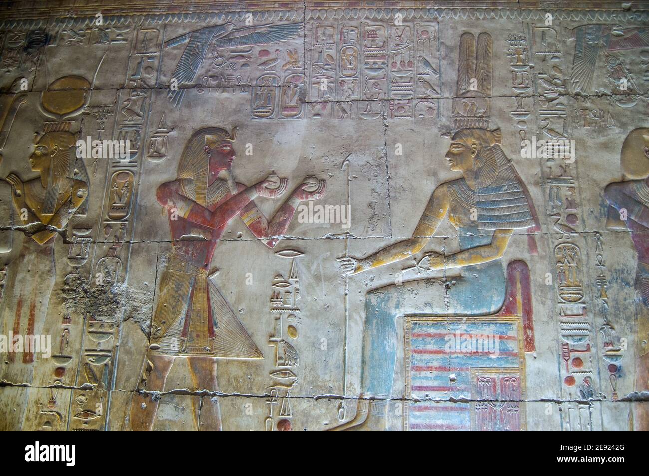 Ancient Egyptian bas relief showing Pharaoh Seti I offering scented oil to the goddess Maat. Inner wall of Temple to Osiris at Abydos, El Balyana, Egy Stock Photo