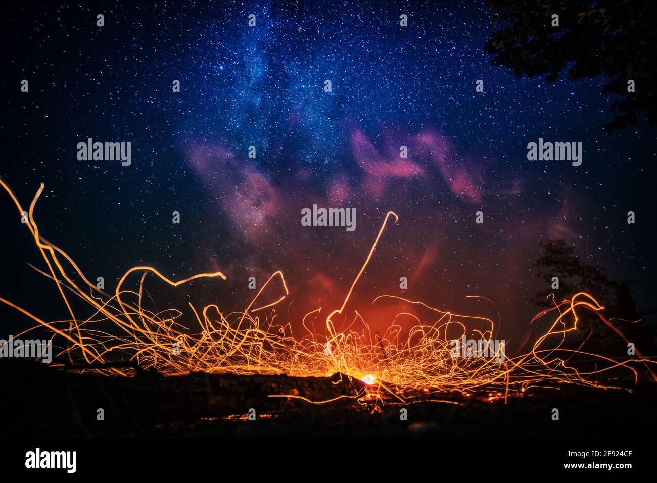 Bright bonfire sparks under starry sky Stock Photo