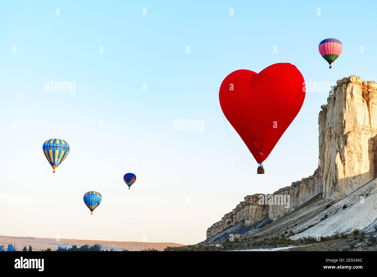 Red heart-shaped air balloon flying in the sky Stock Photo - Alamy