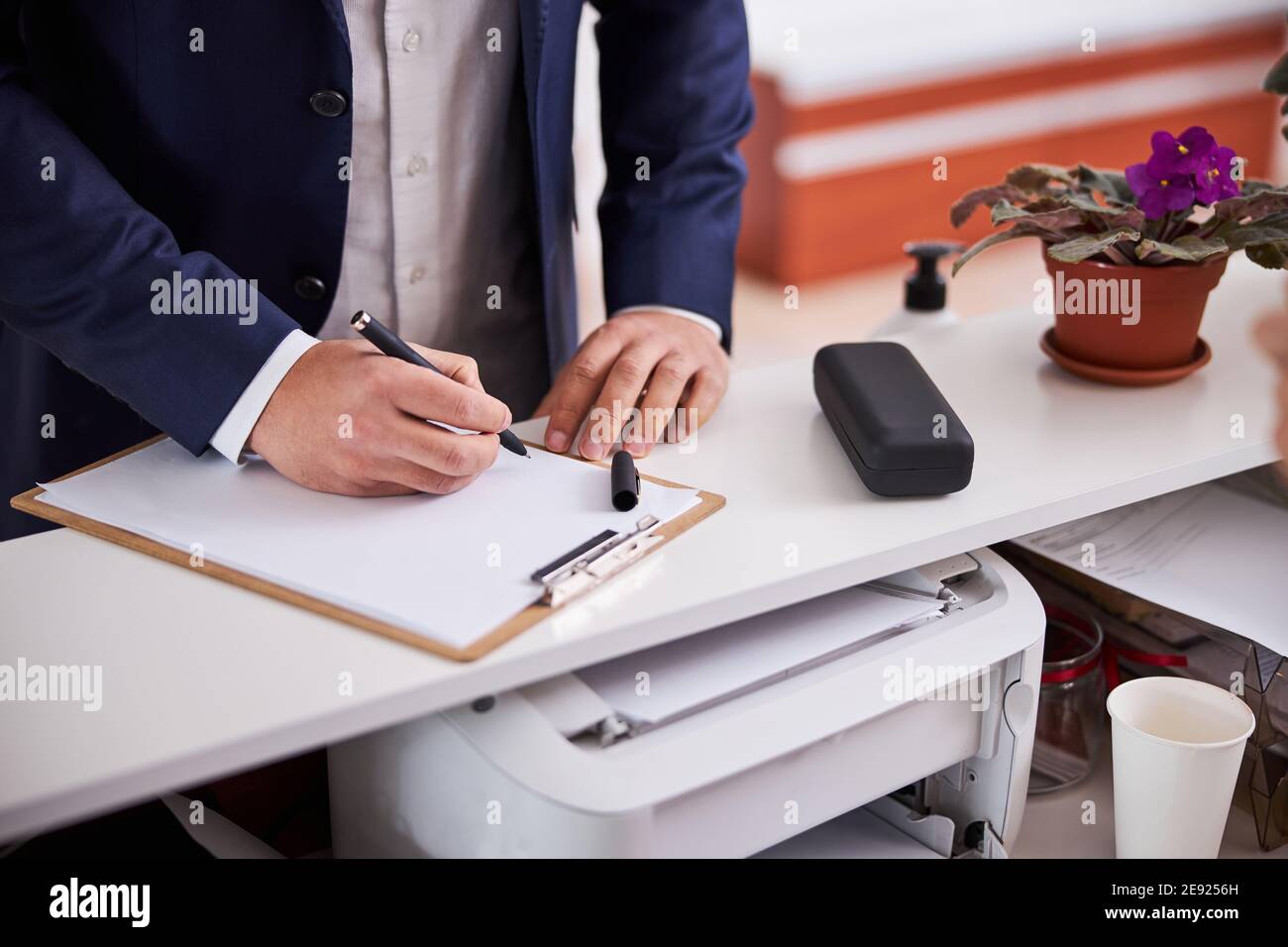 Male client completing an optical prescription form Stock Photo - Alamy