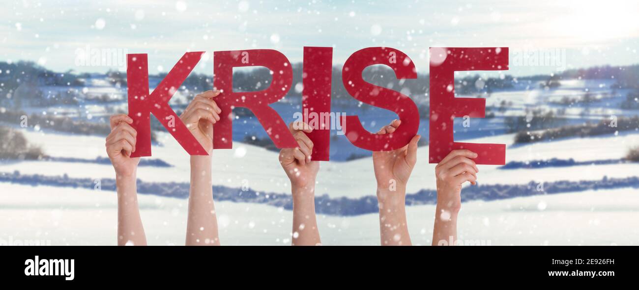 People Hands Holding Word Krise Means Crisis, Snowy Winter Background Stock Photo