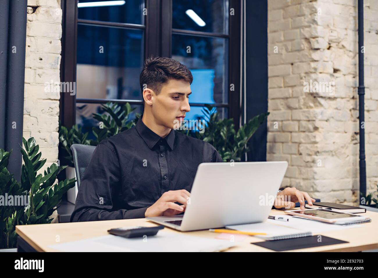 Businessman working on laptop and using tablet Stock Photo