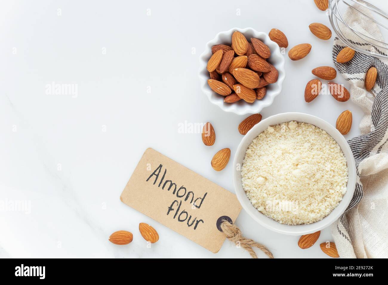Almond flour and almonds in bowls as a Gluten free food concept with an