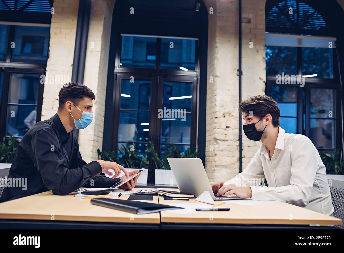 Businessmen in medical masks working in office Stock Photo - Alamy