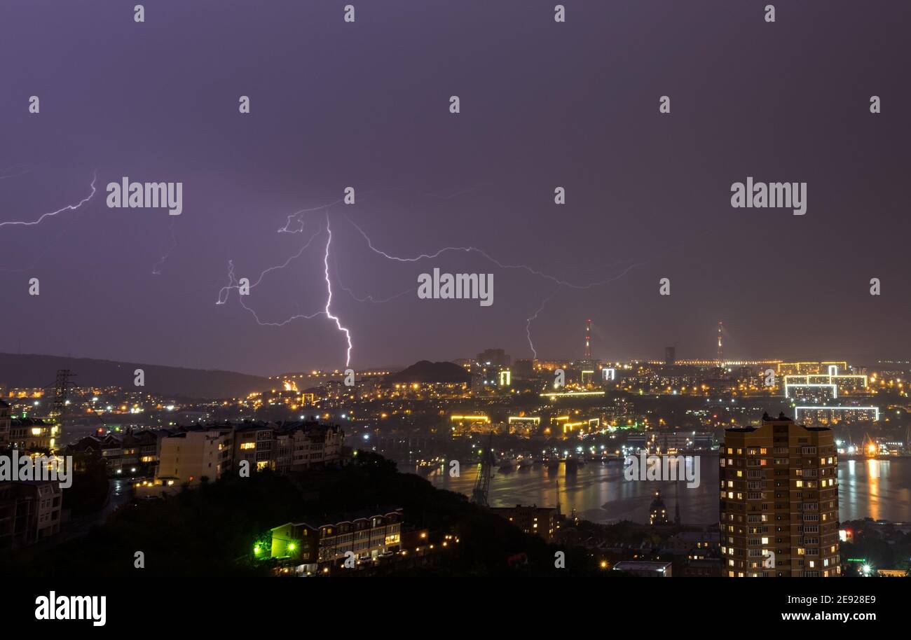 Lightning storm over night city Stock Photo - Alamy