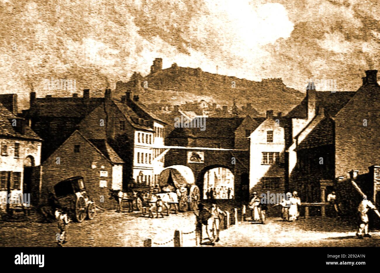 An old engraving taken in Scarborough, North Yorkshire, UK, in the early 1800's showing the former Newborough Bar which was part of the old town walls.. The Bull Inn is sitated to the left of the cart. The bar with its archway  containing the town's jail was rebuilt in 1843 with turrets. In the distance is Scarborough Castle and its walls which were greatly damaged during the bombardment of Scarborough by German Warships. Stock Photo