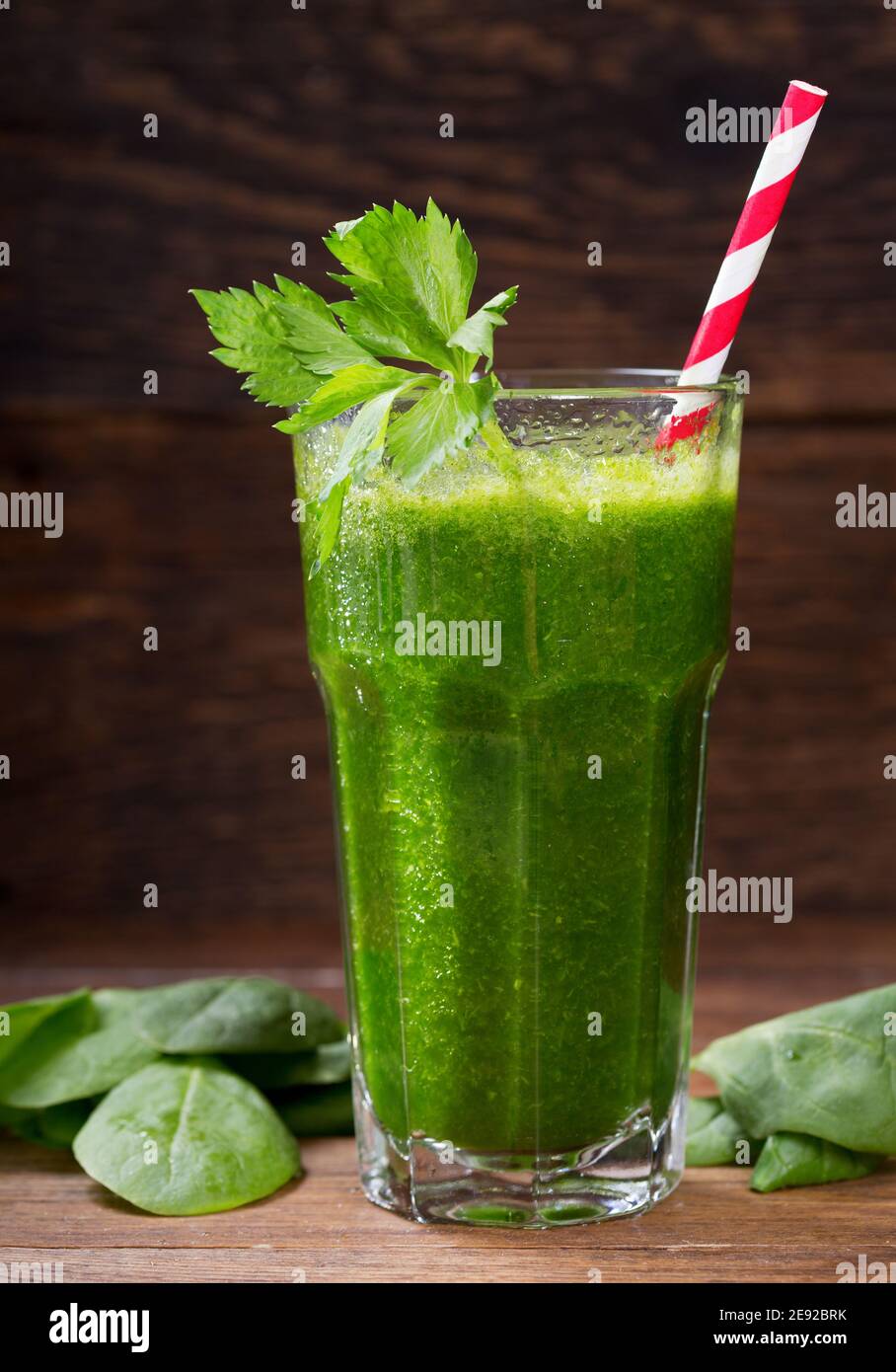 glass of green juice smoothie with spinach on wooden table Stock Photo ...