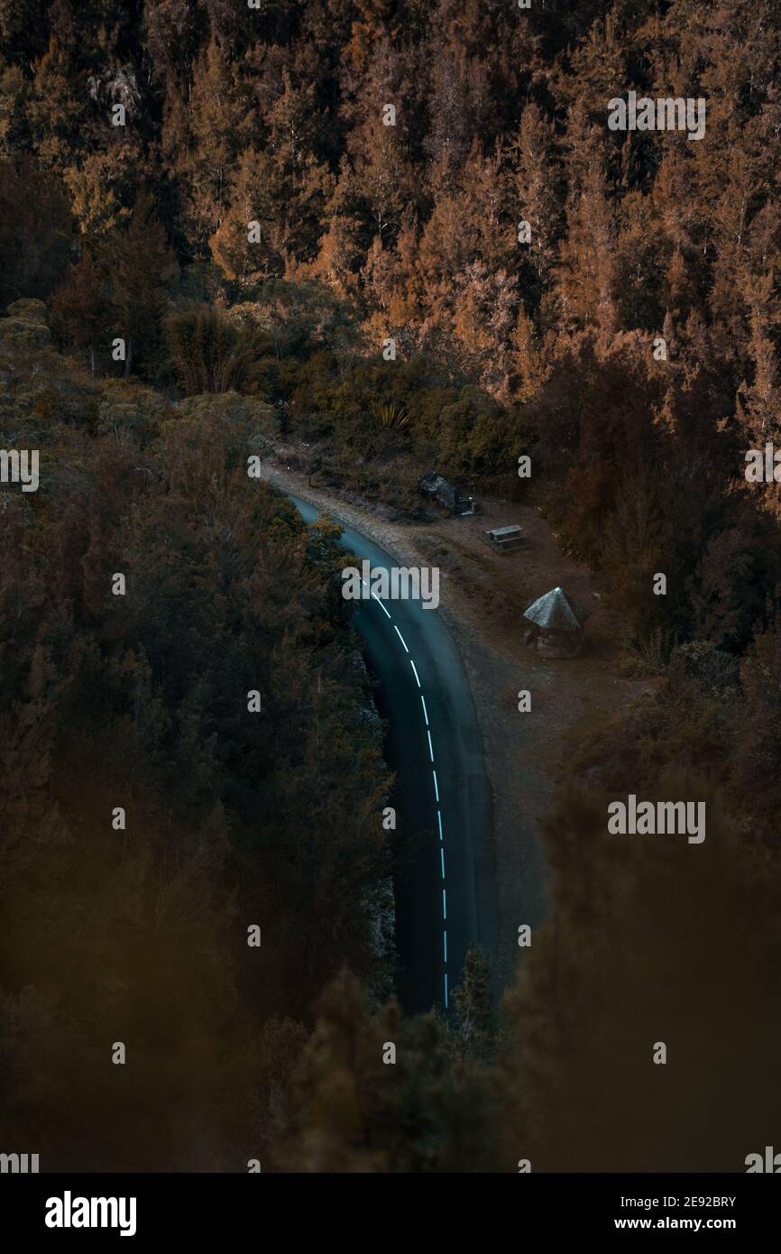 Aerial view of a curved asphalt road on the side of a forest Stock ...