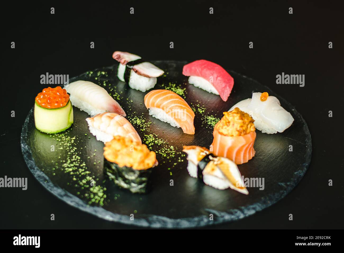 Maki and nigiri sushi variety with salmon, shrimp, avocado and tuna at a sushi restaurant Stock Photo