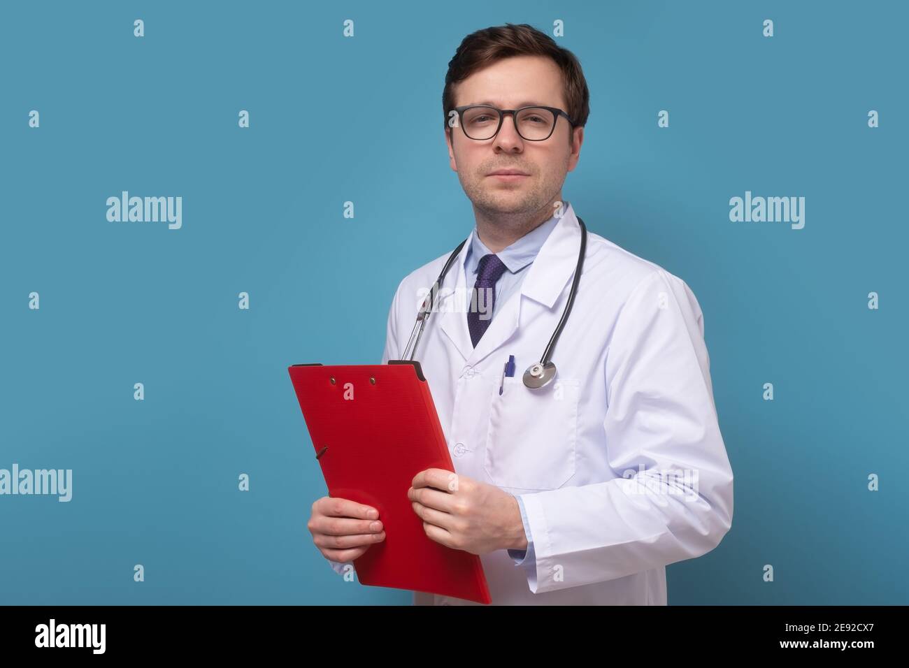 Male doctor standing folder hi-res stock photography and images - Alamy