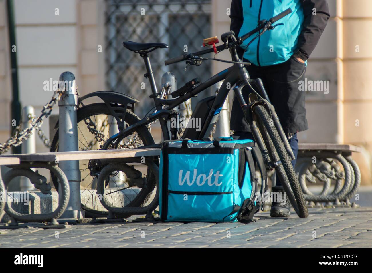 Wolt, food delivery service. Wolt courier with bycicle resting at Old Town Square on February 1st, 2020 in Prague, Czech Republic. Stock Photo