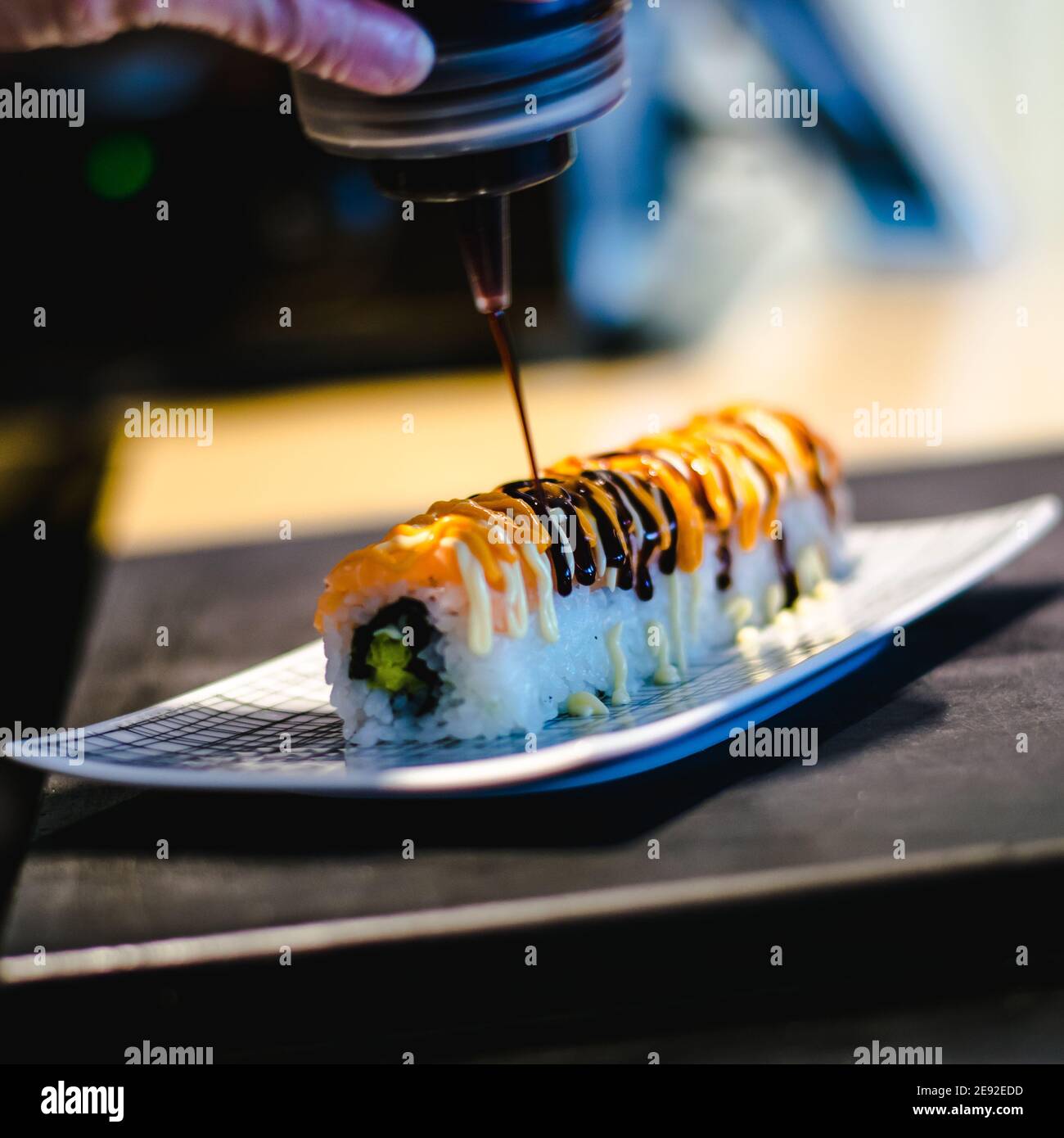 Sushi chef making maki and sashimi sushi at a sushi restaurant Stock