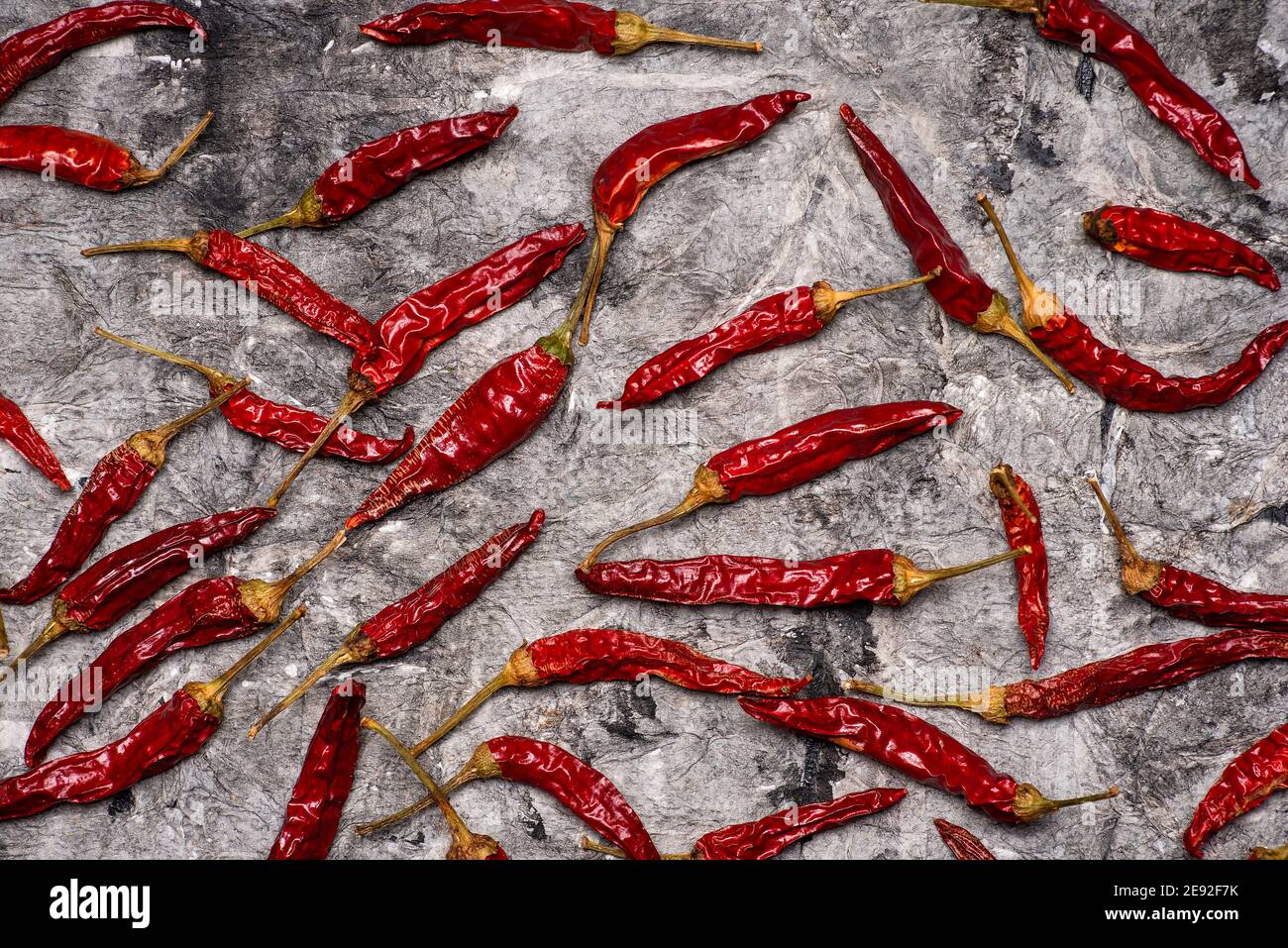 Dry red peppers on a stone table top view flat lay Stock Photo - Alamy