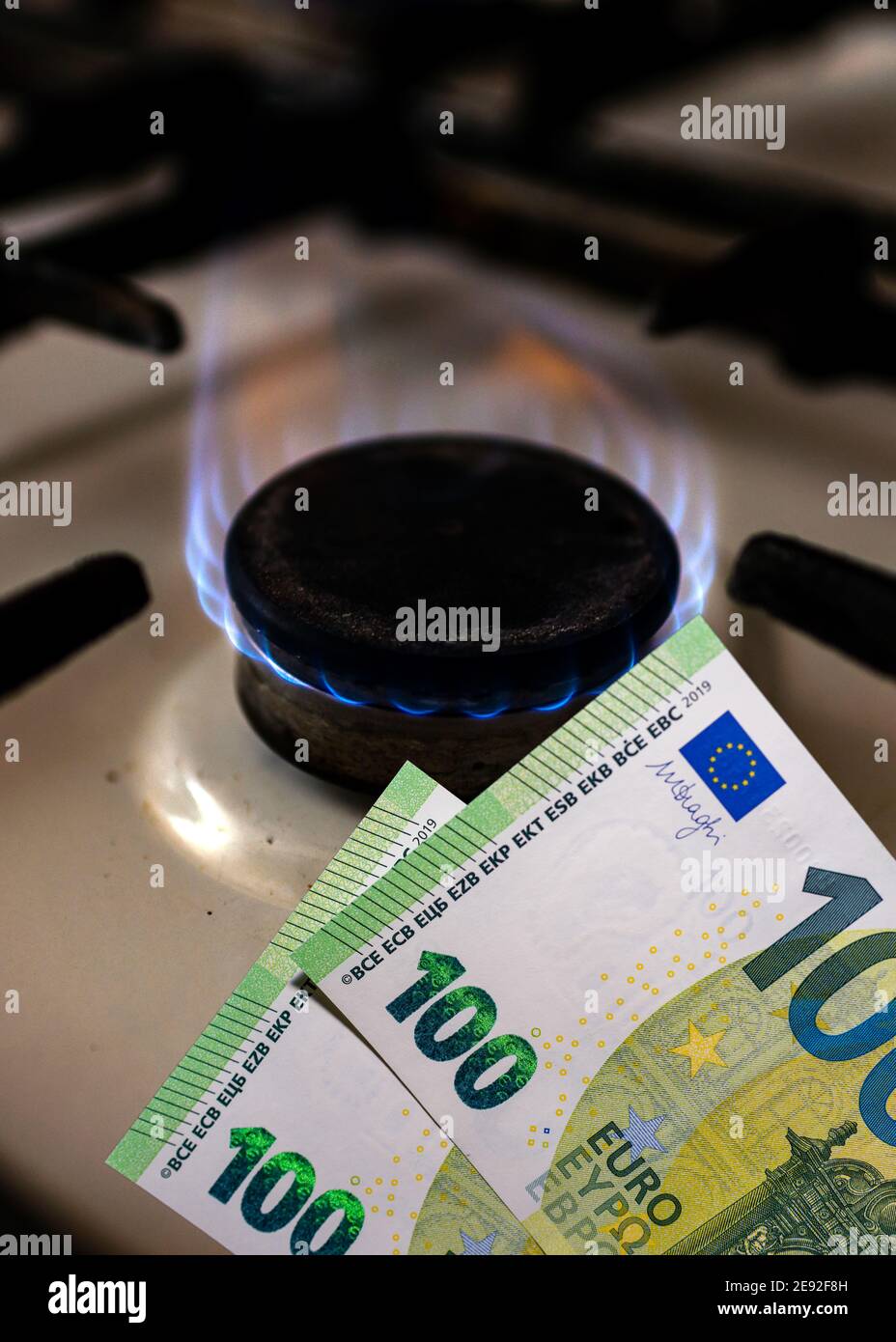 Money and stove.Burning stove flame and one hundred bills two