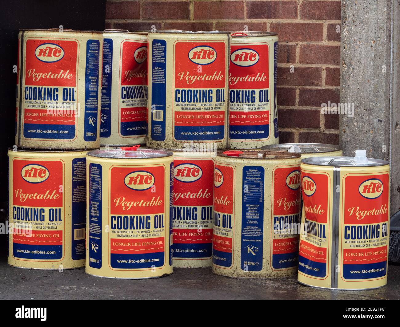 20 litre drums of used vegetable cooking oil stacked up outside a