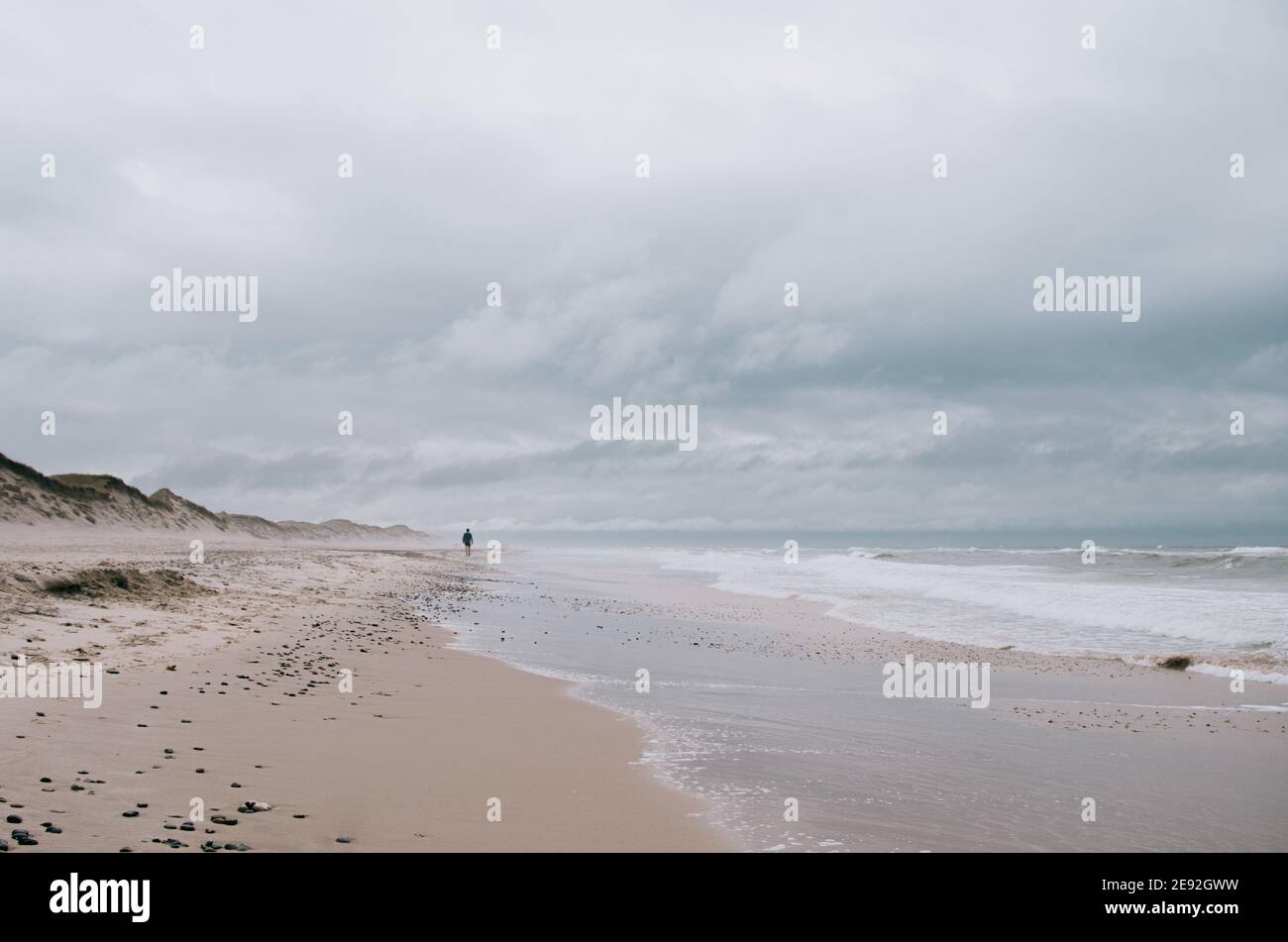 Lonely person walking on sandy hi-res stock photography and images - Alamy