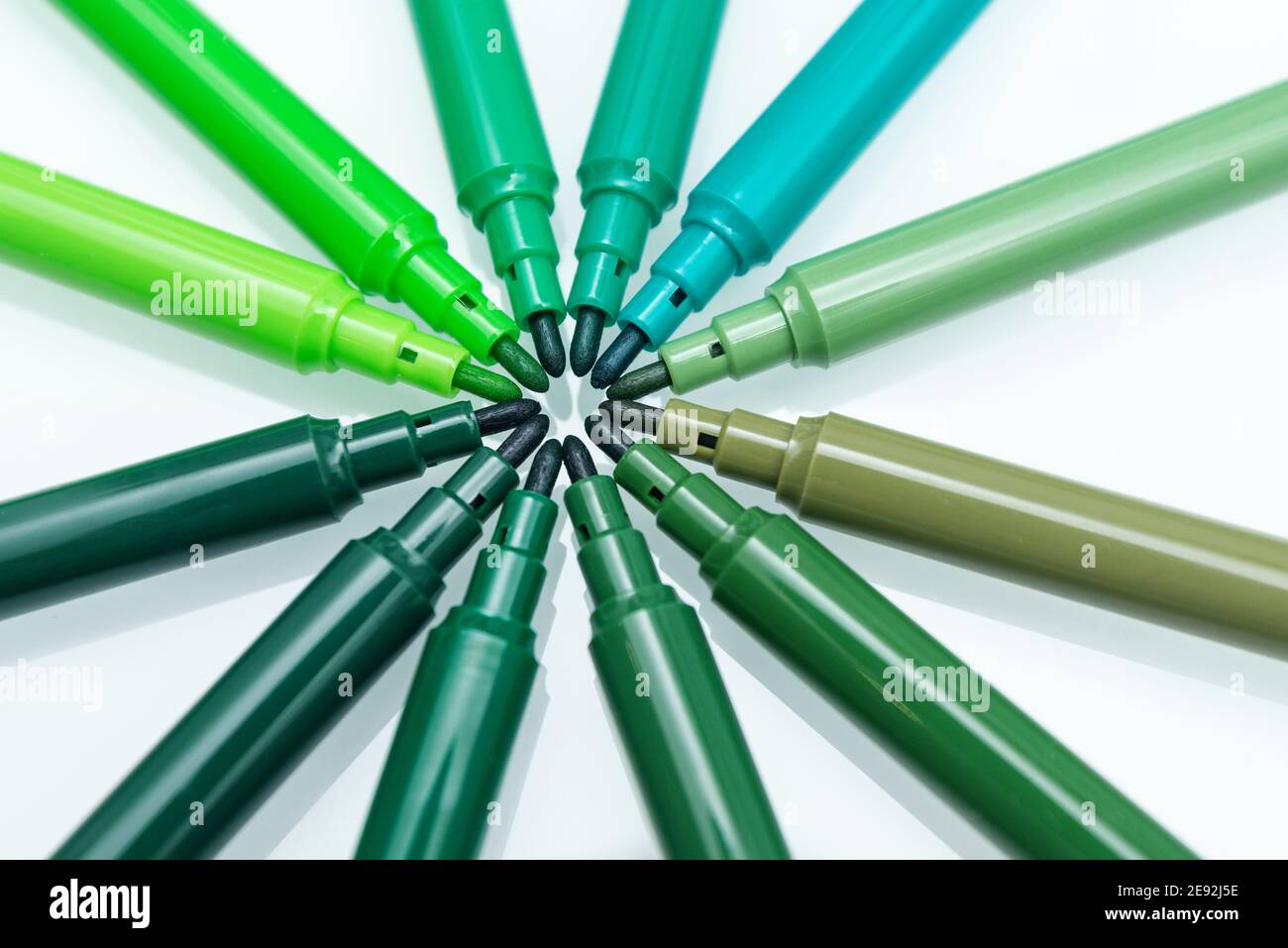 Close up of green colored felt-tip pens on isolated background ...