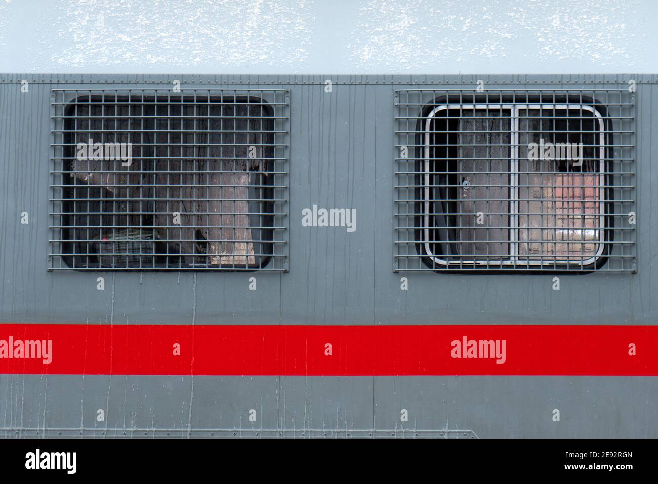 Steel bars on the windows of a russian riot police bus for arrested people at the political rally Stock Photo