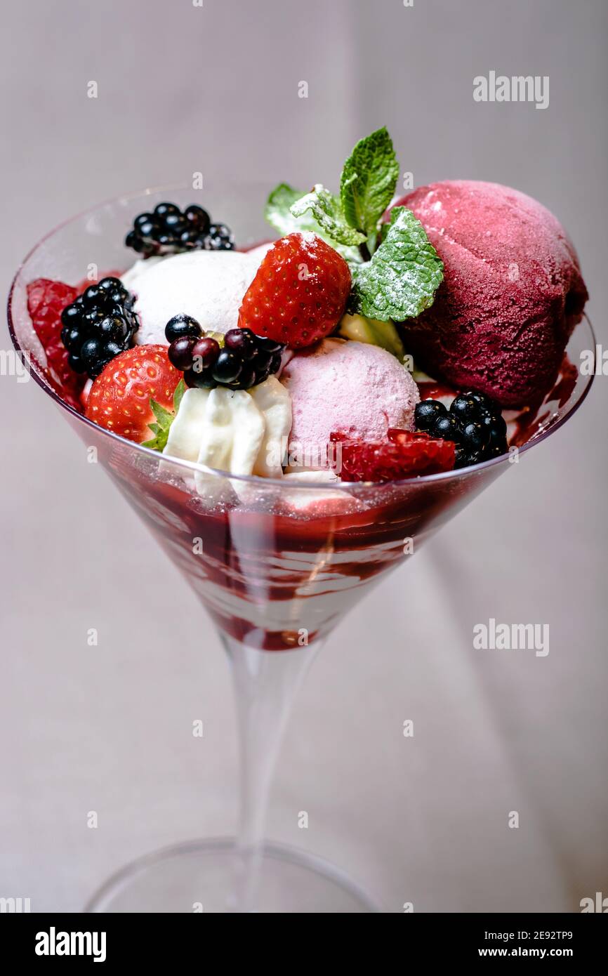 Ice cream serving in a glassware with different berries Stock Photo Alamy