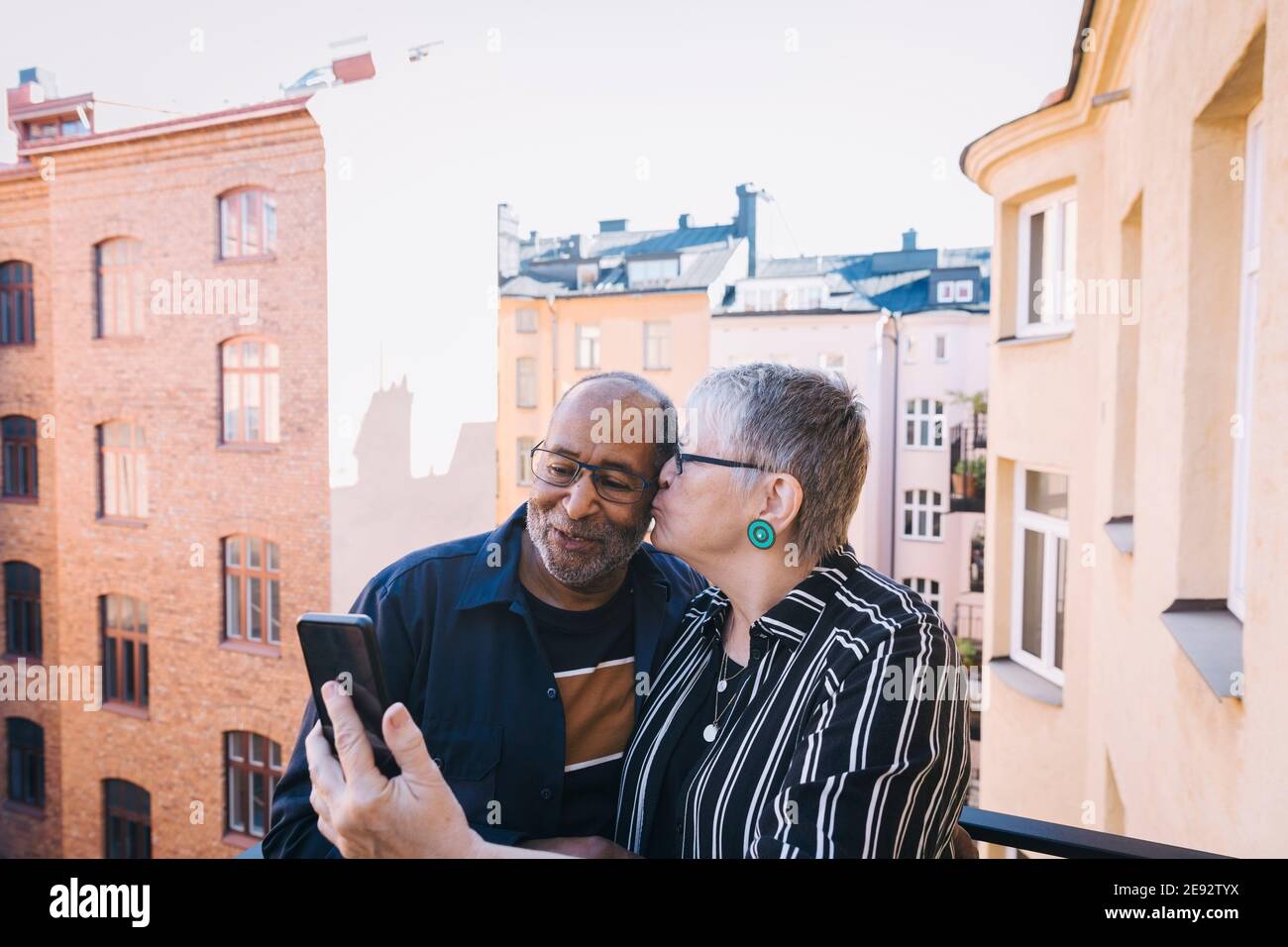 Couple kissing on balcony in hi-res stock photography and images - Alamy