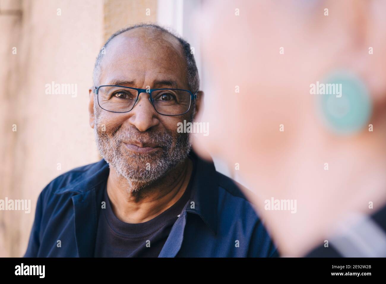 Smiling senior man in balcony Stock Photo