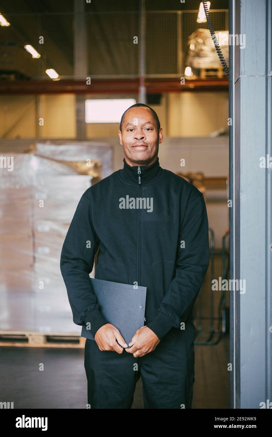 Portrait of smiling male manual worker at warehouse Stock Photo