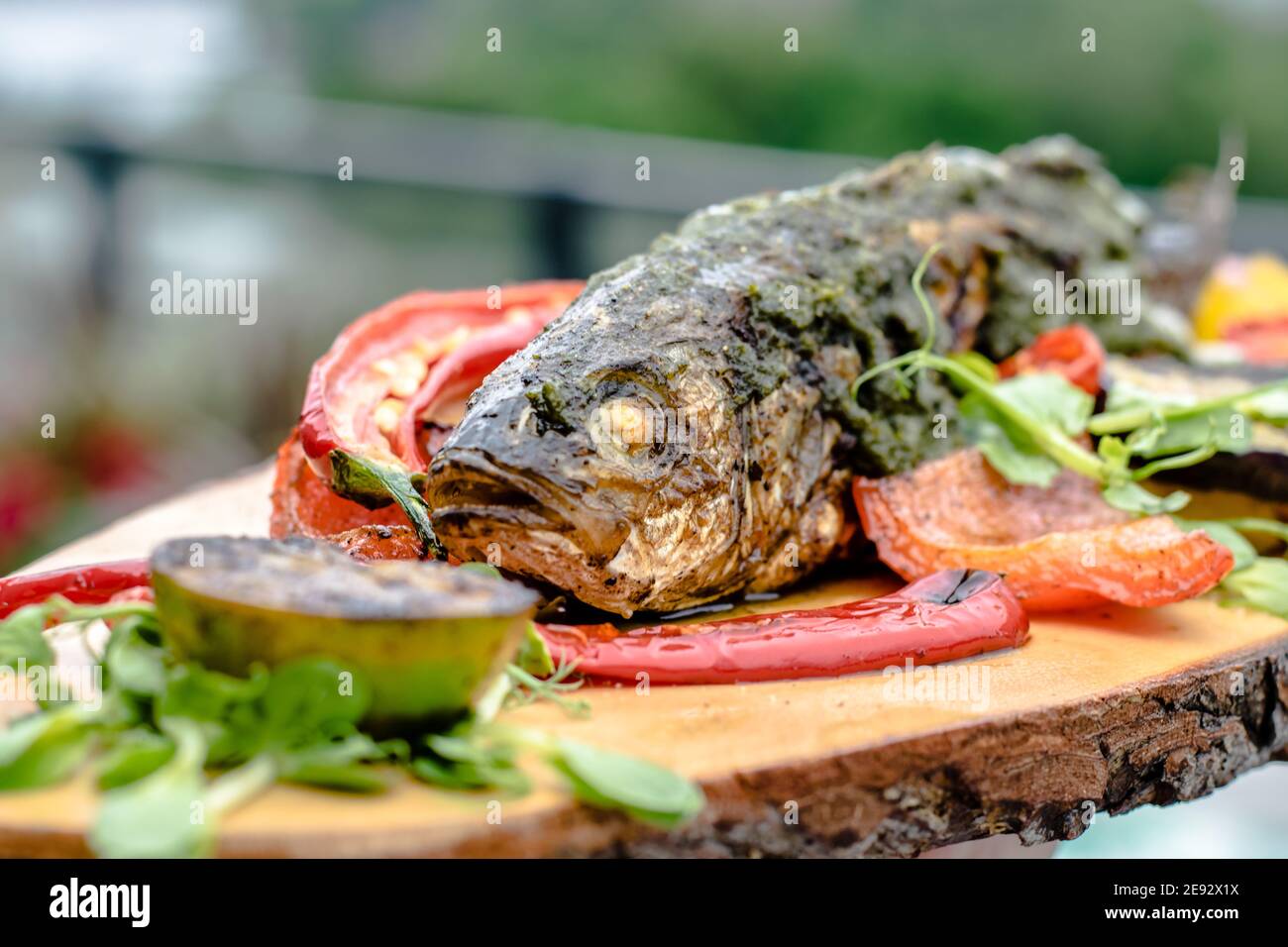 Fried fish on a wood plate at a restaurant Stock Photo