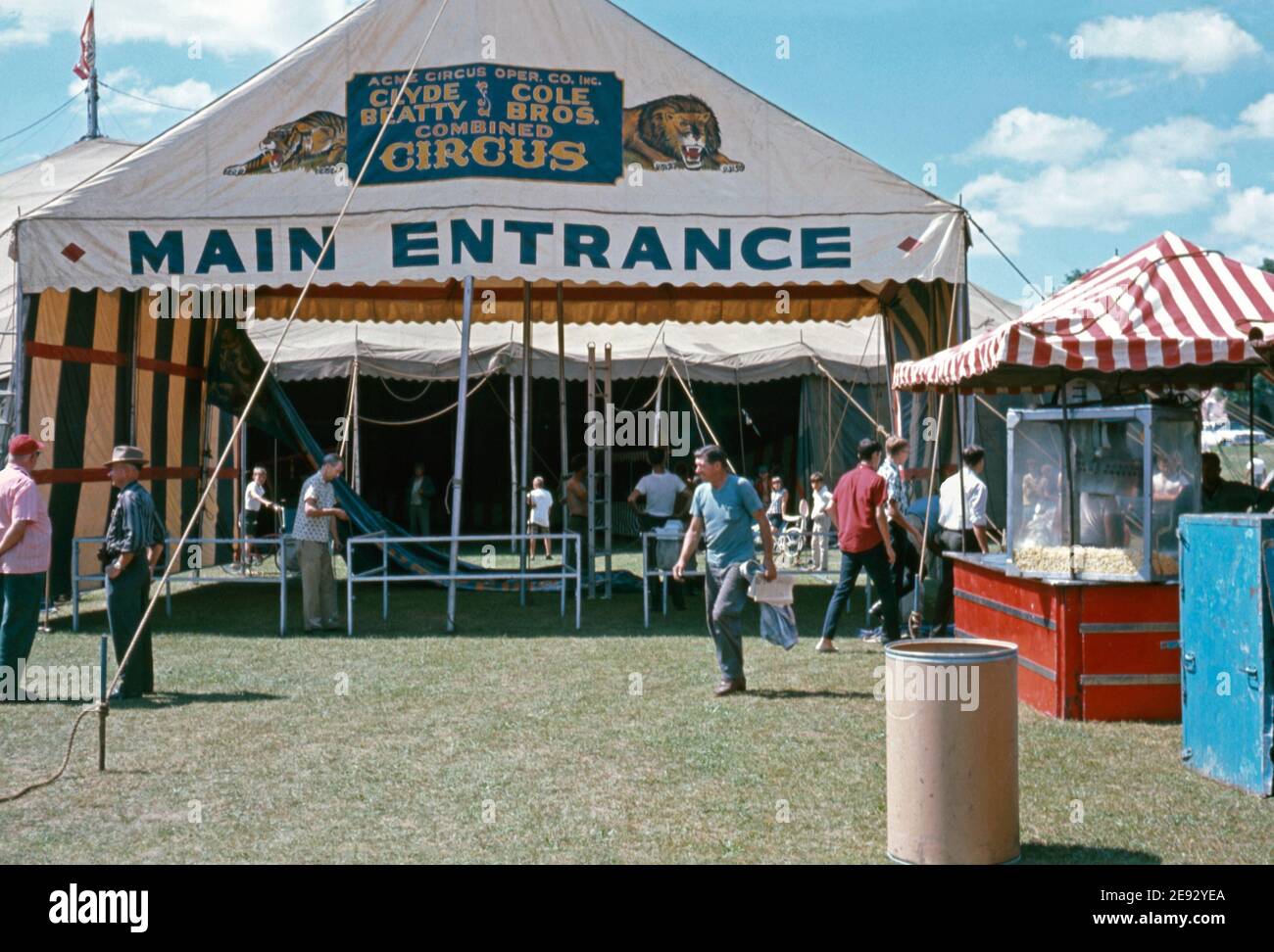 Workers make ready the main entrance to the big top at the Clyde Beatty and Cole Bros Brothers Combined Circus, USA c.1960. The painted banner displayed has a lion and tiger on it. This image is from an old American amateur Kodak colour transparency. Stock Photo