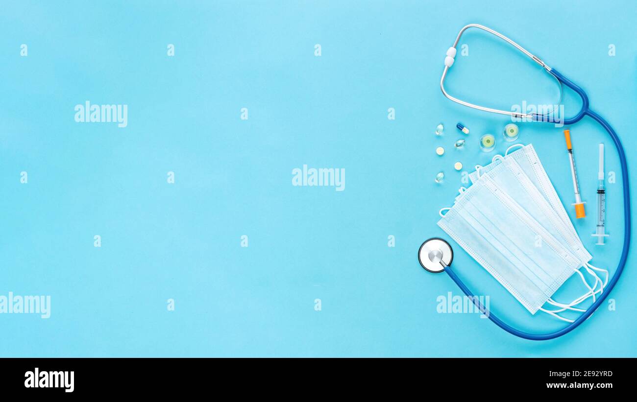 Stethoscope, syringes, vaccine, masks and pills for advertising banner of medical services for COVID-19 vaccination, health and life insurance. Medica Stock Photo