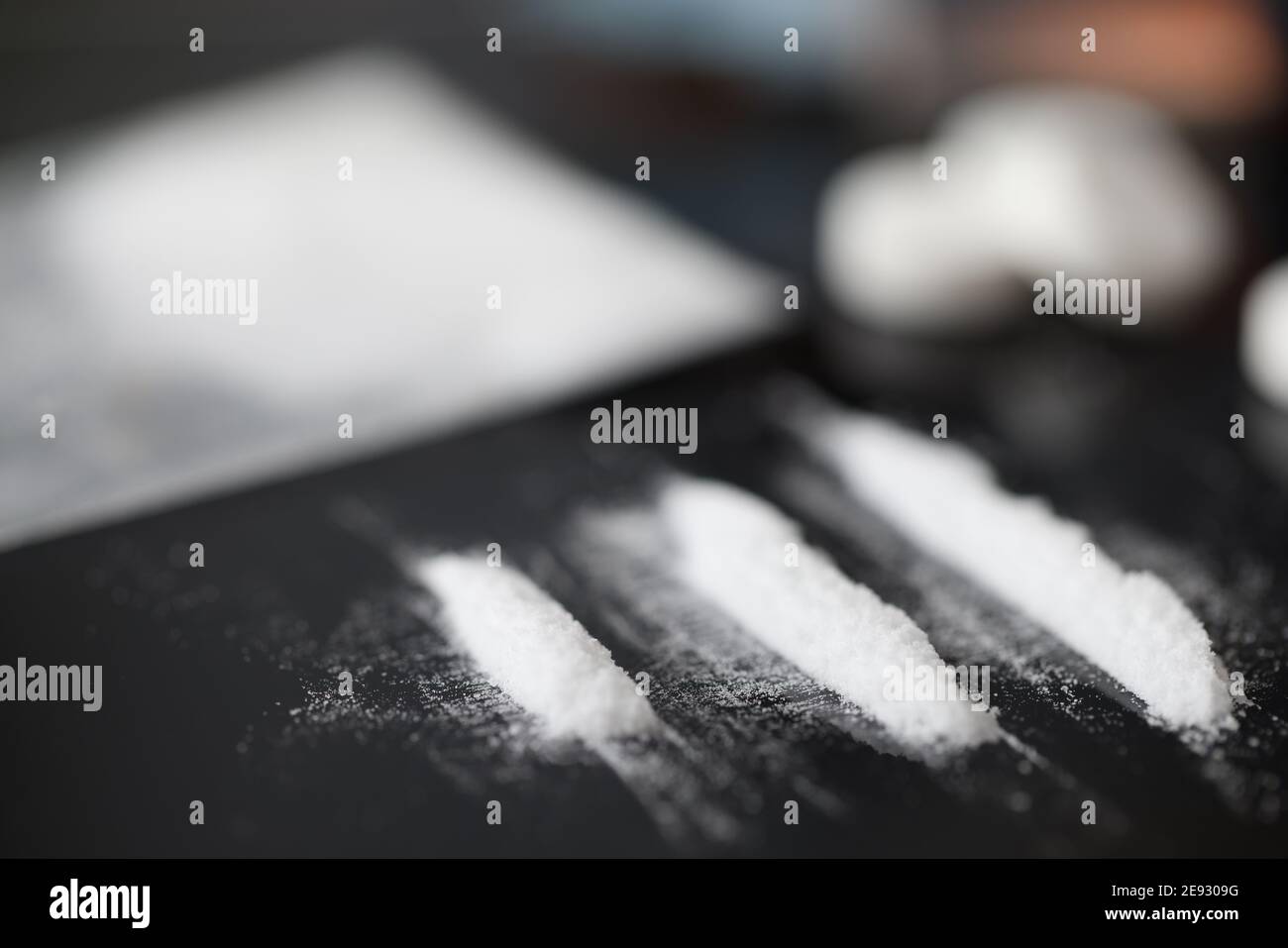 Closeup of white narcotic powder tracks on black background Stock Photo