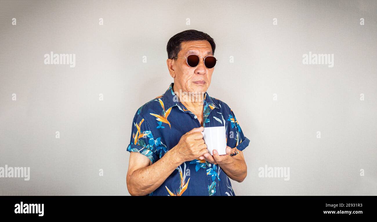Cool senior Asian man drinking coffee Stock Photo