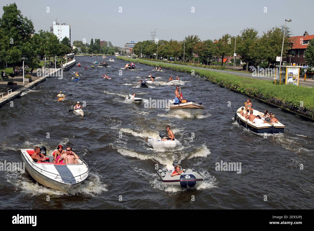 A group of boats in a canal in the Netherlands during high summer season.A pleasure crafts,pleasure boat, recreational craft Stock Photo