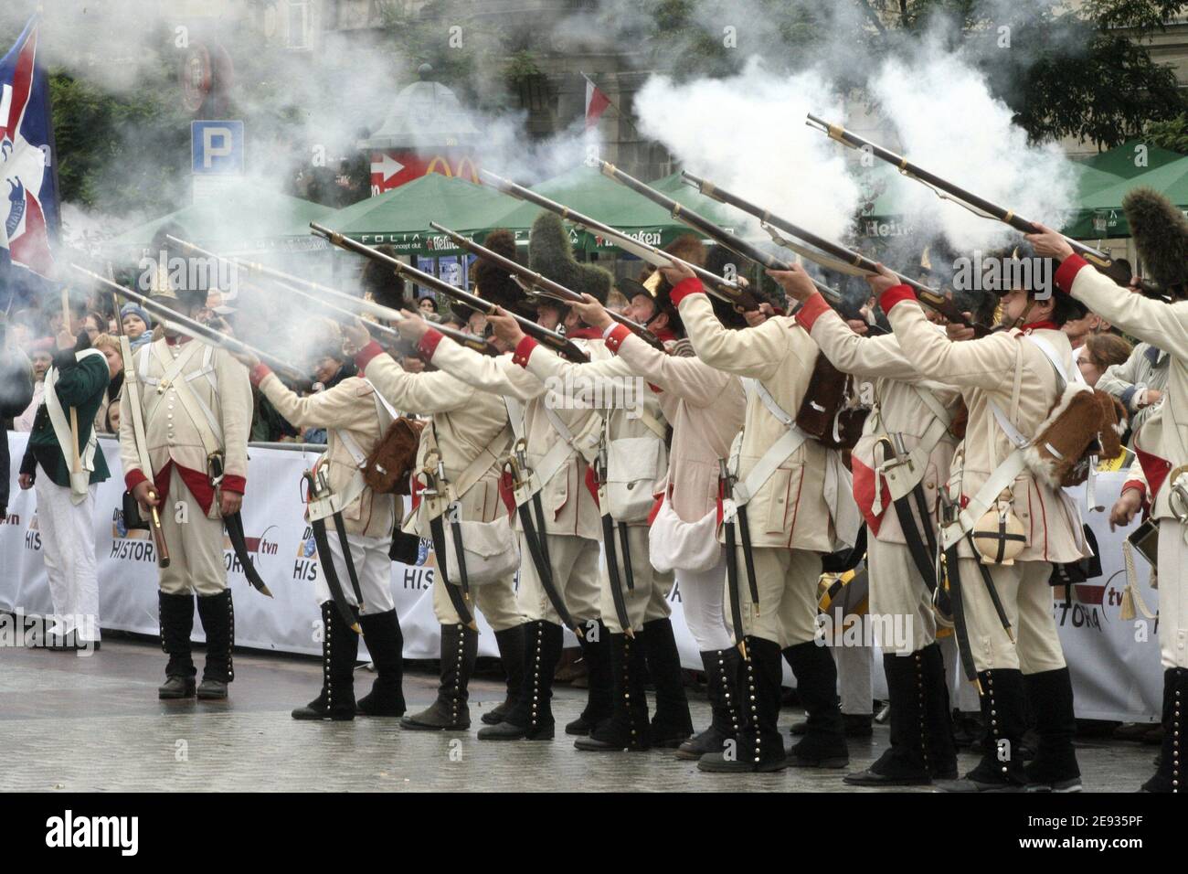 Cracow. Krakow. Poland. Reenactors in uniforms of 18th century Austrian grenadiers fire their rifles in salute. Stock Photo