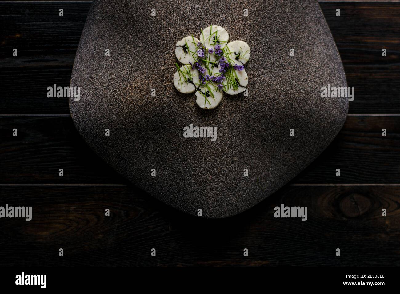 Fish roulade on an interesting plate decorated with fir needles at a ...